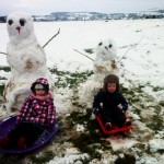 Children build a snowman on Saturday in Derriaghy