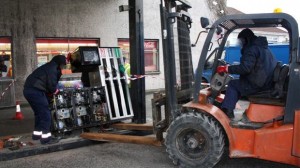 Customs use a forlift truck to remove petrol pumps believed be selling laudered fuel