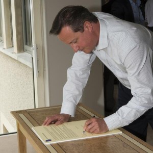 Prime Minister David Cameron signs the Lough Erne Agreement