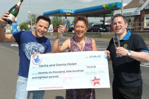Ryan Dolan (left), brother Sacha (right) and his wife Donna with £76,000 Lotto cheque