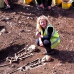 Dr Emily Murray with two of the skeletal remains found at the Bishop Street "dig."