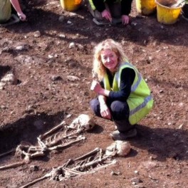 Dr Emily Murray with two of the skeletal remains found at the Bishop Street "dig." 