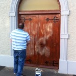 A member of the congregation paints out iRA graffiti on Presbyterian Church