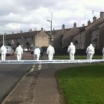 Forensic teams comb the scene of Saturday