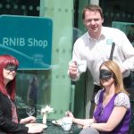 RNIB Northern Ireland’s Joe Kenny serves up the ‘Dining in the Dark’ challenge to Lucy Haugh and Ursula Comican from Fold Housing Association.