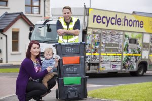 Danielle Shields Oliver Shields with Gareth Townsley from Bryson Recycling put the new ‘Wheelie Box’ to test. 