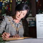 The Mayor Councillor Brenda Stevenson signs a Book of Condolence in memory of broadcaster Gerry Anderson in the Guildhall in his home city. Picture Martin McKeown.