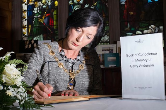 The Mayor Councillor Brenda Stevenson signs a Book of Condolence in memory of  broadcaster Gerry Anderson in the Guildhall in his home city. Picture Martin McKeown.