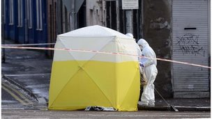 A forensic tent covers the murder scene at Botanic Avenue in south Belfast