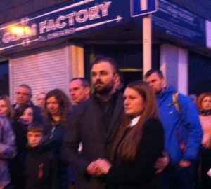 Lithuanian woman Asti surrounded by supporters outside her gutted shop on Tuesday night