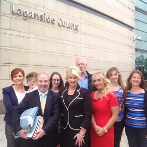 Bernie Smyth (front black dress) with her supporters and solicitor Aiden Carlin outside court this afternoon