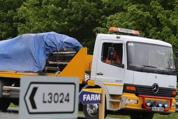 Kathryn Jones's Opel car is taken away from the crash scene