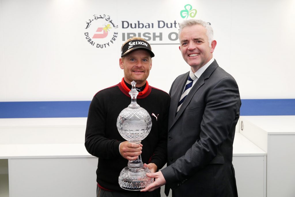 S¿ren Kjeldsen, winner of the Dubai Duty Free Irish Open hosted by the Rory Foundation is presented with the trophy by Enterprise, Trade and Investment  Minister Jonathan Bell. Picture by Kelvin Boyes / Press Eye.
