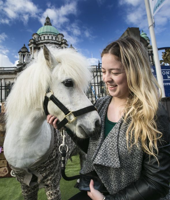 Ponies in PJs ‘Mane’ Attraction at Belfast City Hall: Hamish the Shetland pony was the ‘mane’ attraction cheering up commuters in his PJs at Belfast’s City Hall this morning to shake off any Monday morning blues as VisitScotland research revealed that three quarters of Northern Irish workers are impacted by ‘Sunday Night Fear’ and lack of weekend adventures. Commuter Sarah Adams from Lisburn, is pictured horsing around on her way to work with the miniature star. Picture by Brian Morrison