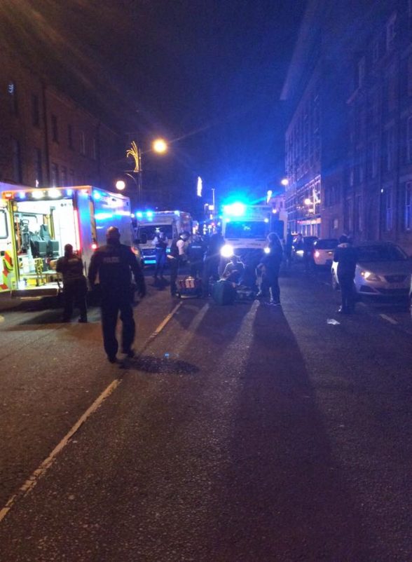 Police teams and paramedics dealing with three collapsed males in Belfast city centre