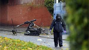 Army bomb experts rmove a suspicious object from a house in north Belfast