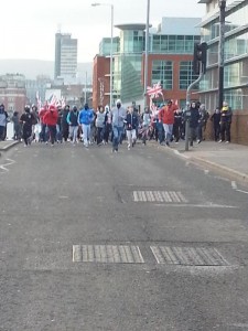 Masked loyalist youths head past Central Station on Saturday
