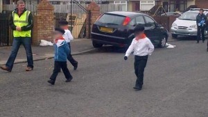 Young children dressed in paramilitary style clothing for dissident republican parade