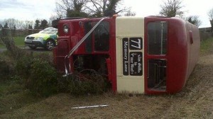 The overturned private double decker bus at scene of Saturday's accident