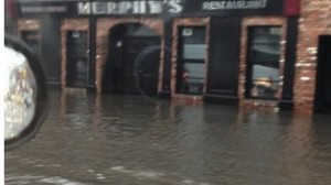 A river of water races past Bartley Murphy's bar in Downpatrick