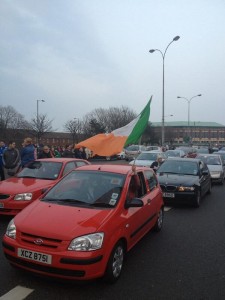 Crowds gather on Falls Road as a cavalcade of cars brings west Belfast to a standstill on Tuesday night