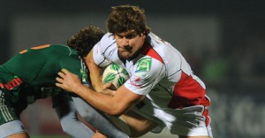 Robbie Diack sees off a Scarlets tackle at Ravenhill