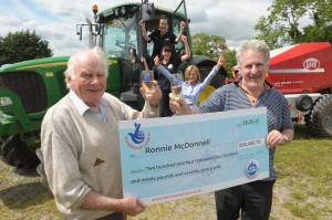 Farmer Ronnie McDonnell (left) celebrates his whopping £204,490.70 Euromillions win with Seamus McNamee, owner of the Costcutter store in Jonesborough, Newry where Ronnie purchased his ticket plus staff members (from the top) Susan Clarke, Angela Rafferty and Marie McNamee.