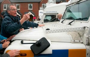A stand off between Gerry Kelly and one of the PSNI's riot squad landrovers