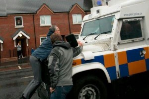 Sinn Fein MLA Gerry Kelly carried by PSNI landrover during Tour of the North parade last summer