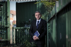 IFI Chairman Dr Adrian Johnston at a peace wall on the Springfield Road in west Belfast