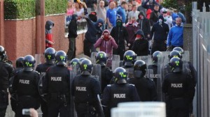 Police confront loyalist rioters in the Woodvale area of north Belfast on Saturday evening