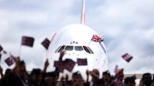 British Airways wave flags in front of a British Airways Airbus A380, the world's largest passenger plane, at Heathrow Airport, as BA became the first UK airline to take delivery of the massive superjumbo.