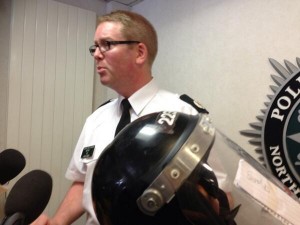 ACC Will Kerr and a PSNI riot helmet which he said was dented with a ceremonial sword during violence in Belfast