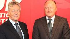 Alderman Frank McCoubrey (right) condemns damage cause to fence around new Shankill homes