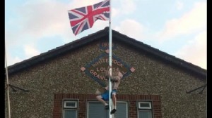 A man captured on video climbing up flag pole at Whiterock Orange Hall