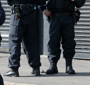 The remains of a device at the feet of PSNI officers on Monday in north Belfast