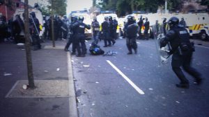 Police officer lies injured during rioting in Belfast on the Twelfth of July