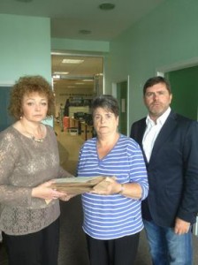 Caral Ni Chuilin hands over the papers to Clara Reilly and Mark Thompson from Relatives for Justice. Picture: Relatives for Justice