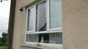 The smashed window of a Protestant family's home in Kells Avenue, west Belfast