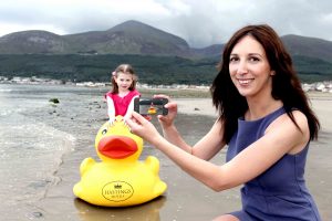 PHOTO TIME... Charlotte Jess from the Northern Ireland Tourist Board (NITB) and Anna Phenix, aged 7, complete one of the tasks during the launch of NITBs MyNI photo competition.  