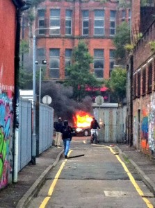 A car is set on fire in north Belfast as loyalists and republicans riot