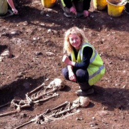 Dr Emily Murray with two of the skeletal remains found at the Bishop Street "dig."