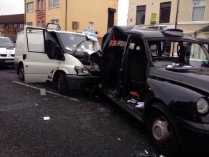 The scene of the accident in west Belfast where a white van has rear ended a black taxi