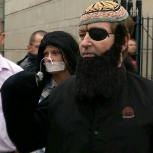 Willie Frazer dressed as 'Hook Hamza' for his court appearance in Belfast alongside Jamie Bryson with tape over his mouth