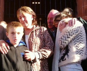 family Mr McCrory's son Shea, mother Anne and father Danny during this morning's silent tribute.