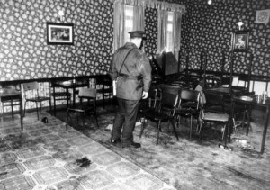 An RUC officer observes the aftermath of the Rising Sun pub massacre in 1993