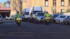 A convoy of police vehicles bring dissident republican suspects to court in Glasgow