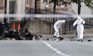 The aftermath of a bomb attack on Strand Road police station in August 2012