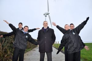 Philip Rainey, Simple Power (centre) is pictured alongside Nathan Garland-O’Neill, David Curran, Ryan Hanna and Mark Quigley from Corpus Christi College, as they visited the company’s single wind turbine at Jim McCord’s farm
