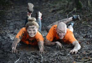 MUDDY MAYHEM... Online fitness enthusiast Peanut Butter Girl aka Tiffany Brien gets jaffa-caked in mud alongside the reigning McVities Jaffa Cakes Mud Madness champion Keith Clarke ahead of this years race.  